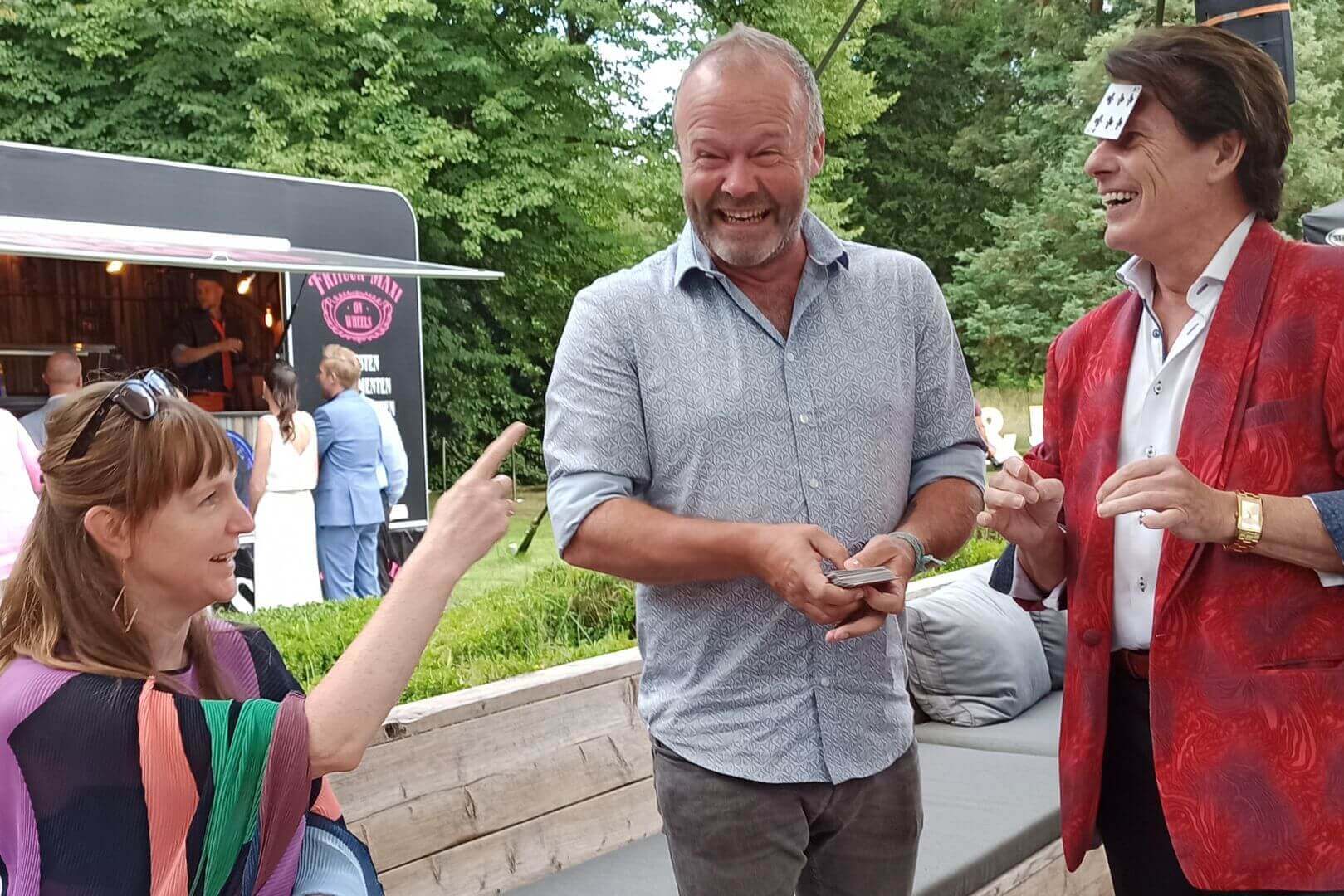 Belgian Actor Steven Goegebeur laughs in surprise when he sees his chosen card on Tony's forehead.