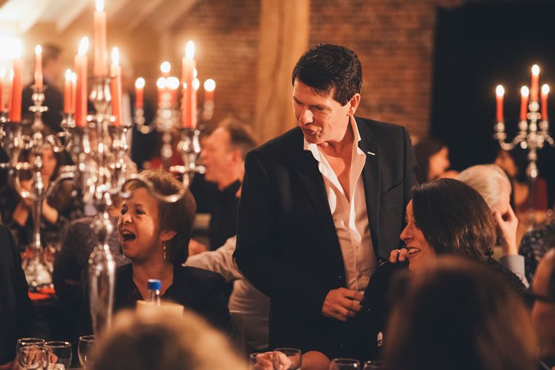 As a table magician, Tony ensures smiling faces during his performance at a company party.