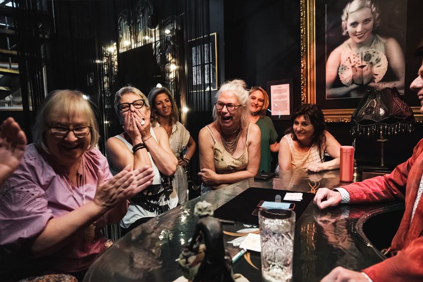 Ladies react enthusiastically to the magic of magician Tony Price