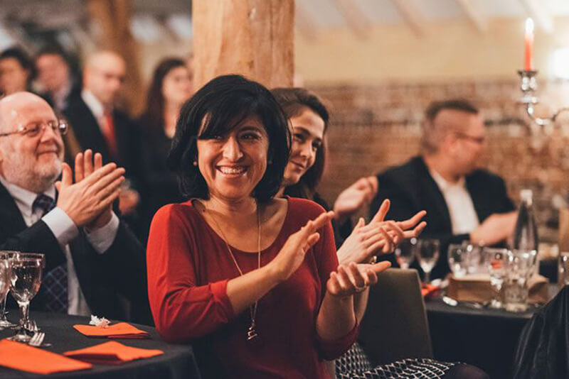 Lady applauds during magician Tony Price's stunning magic show.